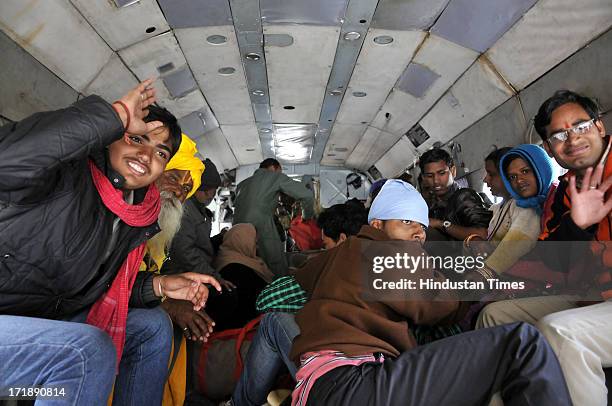 Pilgrims smiling after been rescued from Badrinath at Joshimath helipad on June 29, 2013 in Joshimath, India. Continuous helicopter service rescuing...