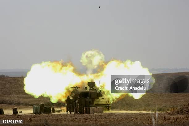 Fire and smoke rise as Israeli artillery units stationed in the military zone launch attacks during the fifth day of the clashes in Sderot, Israel on...