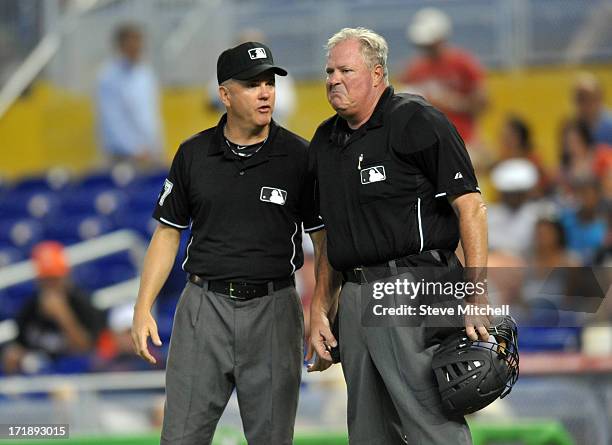 Umpire's Mike Everitt, left, talks with Tim Welke, right, during a game between the Minnesota Twins and the Miami Marlins at Marlins Park on June 26,...