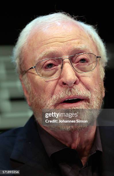 British actor Sir Michael Caine gestures during a panel talk at The Black Box during the Munich film festival on June 29, 2013 in Munich, Germany.