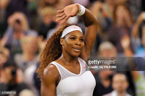 Player Serena Williams celebrates beating Japan's Kimiko Date-Krumm in their third round women's singles match on day six of the 2013 Wimbledon...