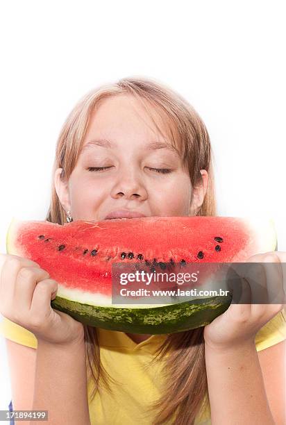 blond girl eating watermelon - comendo stock-fotos und bilder