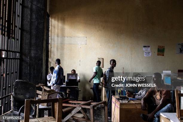 Men set up their printing stalls inside the old central bank in Monrovia on October 11, 2023.