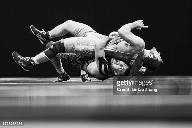 Rustam Assakalov of Uzbekistan competes against Islam Umayev of Kazakhstan in the men's 97 kg greco-roman Bronze medal Wrestling event during the...