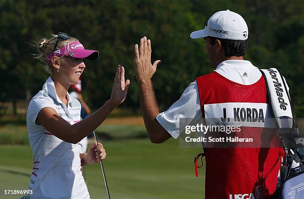 Jessica Korda celebrates a par saving putt on the 14th green with her caddie/boyfriend Johnny DelPrete during the third round of the 2013 U.S....