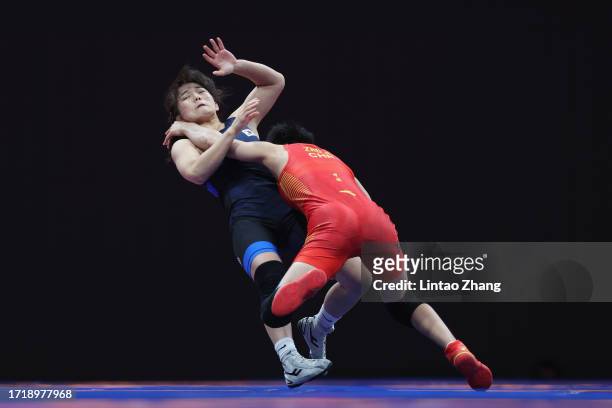 Zhu Jiang of China competes against Chen Miran of South Korea in the women's 50 kg freestyle Bronze medal wrestling event during the 2022 Asian Games...