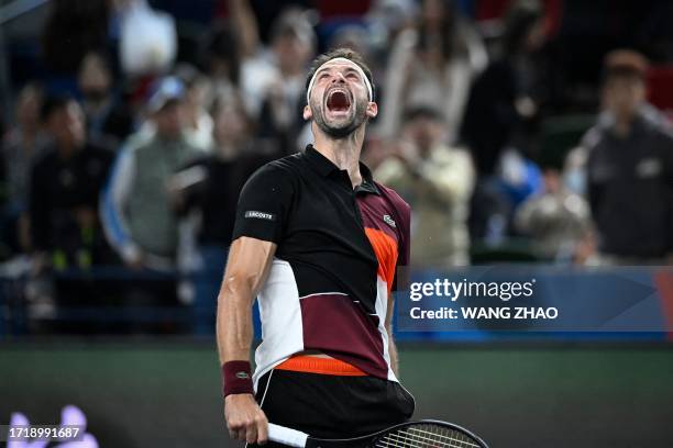Bulgaria's Grigor Dimitrov celebrates after winning against Spain's Carlos Alcaraz during their men's singles match at the Shanghai Masters tennis...