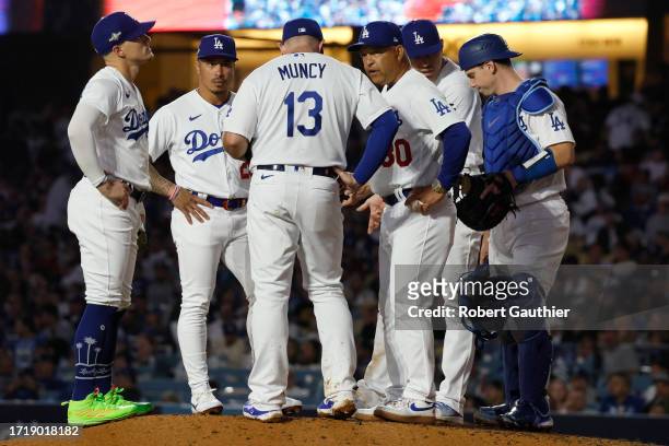 Los Angeles, CA, Monday, October 9, 2023 -Los Angeles Dodgers manager Dave Roberts chats with infielders as relief pitcher Evan Phillips is summoned...