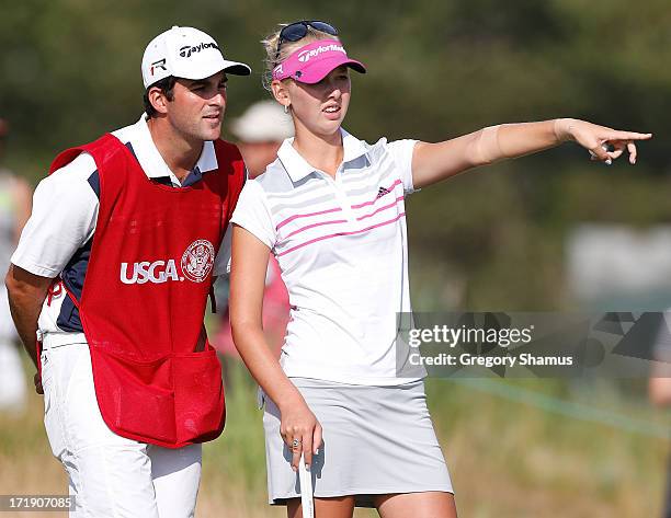 Jessica Korda discusses a putt on the 16th green to her caddie/boyfriend Johnny DelPrete during the third round of the 2013 U.S. Women's Open at...