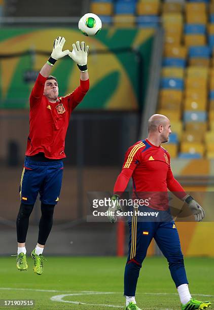 Iker Casillas of Spain catches the ball as Pepe Reina looks on during a training session, ahead of their FIFA Confederations Cup Brazil 2013 Final...