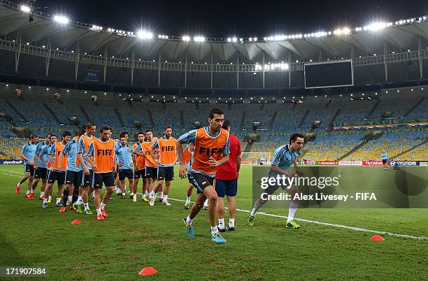 Sergio Busquets and Xavi Hernandez of Spain sprint during a training session, ahead of their FIFA Confederations Cup Brazil 2013 Final match against...