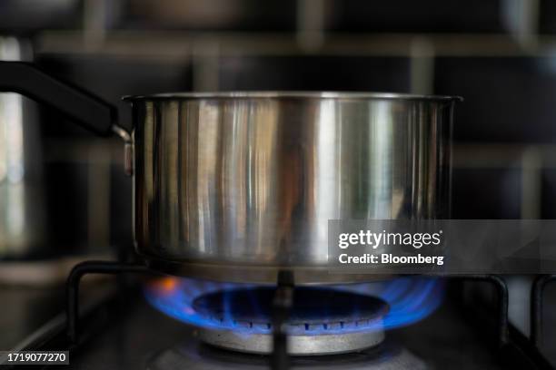 Pan of water heated by natural gas burning on a domestic kitchen stove in London, UK, on Tuesday, Oct. 11, 2023. Prices jumped this week amid...