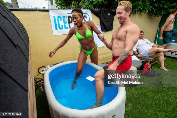 Chaterra Moring of Los Angeles, and Brent Hollingworth of Culver City, enter an ice bath with the temperature set to 38 degrees during a singles...