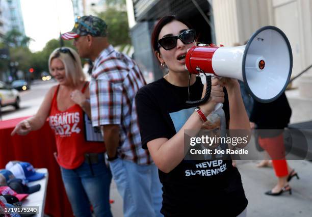 Laura Loomer shows her support for former President Donald Trump outside a campaign event for Republican presidential candidate Florida Gov. Ron...