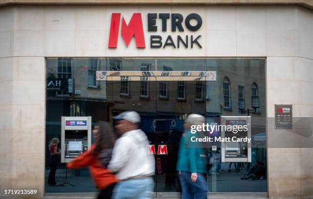 People pass a the exterior of a branch of Metro Bank on October 05, 2023 in Bath, England. Metro Bank is in talks with investors to raise up to...