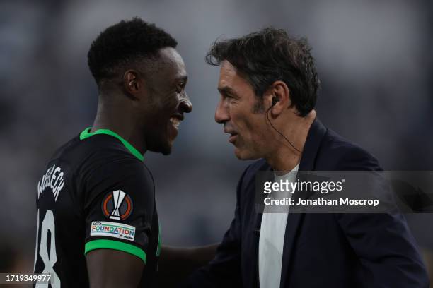 Danny Welbeck of Brighton discusses with former Arsenal and France winger Robert Pires following the final whistle of the UEFA Europa League Group B...
