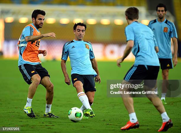 Xavi Hernandez and Cesc Fabregas of Spain in action during a training session, ahead of their FIFA Confederations Cup Brazil 2013 Final match against...