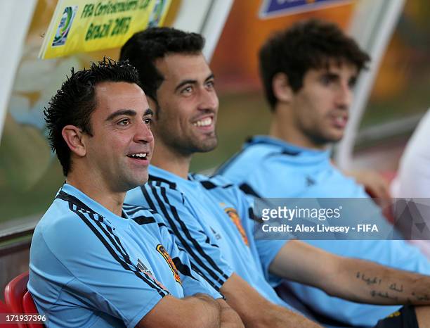 Xavi Hernandez, Sergio Busquets and Javi Martinez of Spain sit on the bench during a training session, ahead of their FIFA Confederations Cup Brazil...