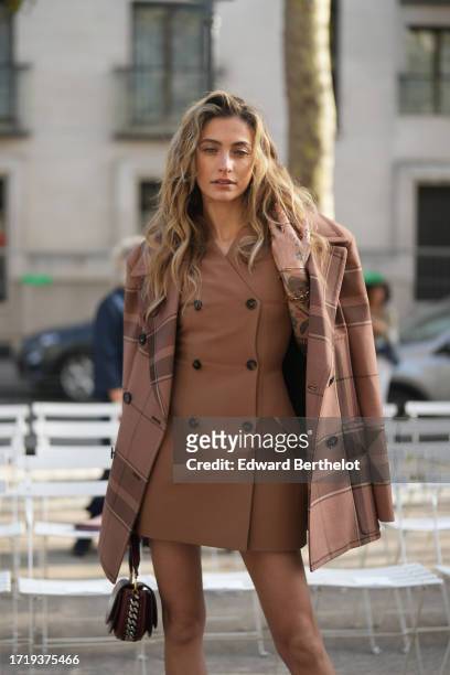 Paris Jackson wears a brown oversized checkered blazer jacket, a brown leather double breasted short coat worn as a mini dress, a bag,, before Stella...