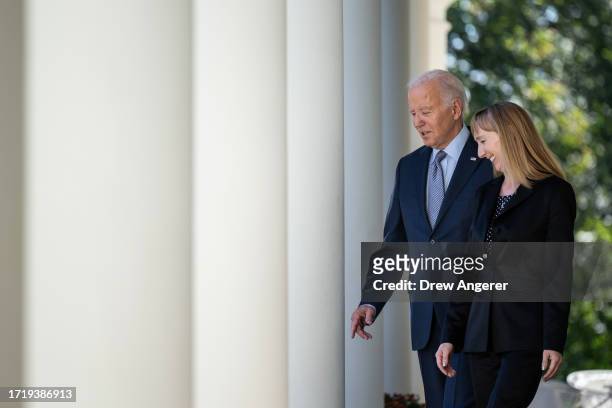 President Joe Biden walks with Becky Chong, a stay-at-home mom who has experienced junk fees, as he arrives to deliver remarks on new efforts to...