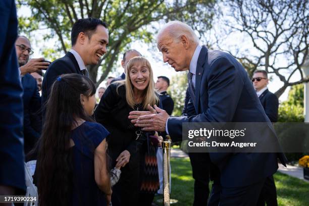 President Joe Biden greets Becky Chong , a stay-at-home mom who has experienced junk fees, and her family after speaking on new efforts to crack down...