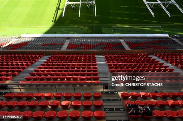 Visitors sit on the stands in the Allianz Arena Stadium, home stadium of German first division football club FC Bayern Munich, in Munich, southern...