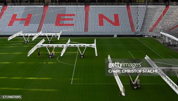 Machines for the regeneration of the football pitch are set up at the Allianz Arena Stadium, home stadium of German first division football club FC...