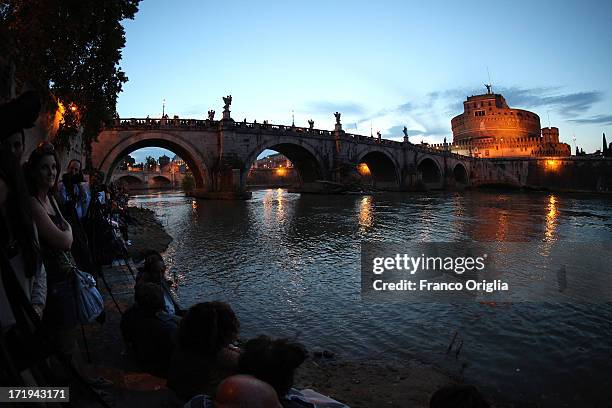 People gather along the Tiber to wait for the traditional 'La Girandola' fireworks over Castel Sant'Angelo on June 29, 2013 in Rome, Italy. The...