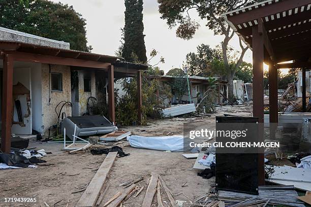 Graphic content / A picture shows a victim in a body bag as Israeli rescuers and troops search the scene of an attack in the Israeli kibbutz of Kfar...