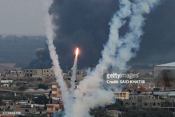 Palestinian militants fire rockets towards Israel from Rafah, southern Gaza Strip, on October 11, 2023. Israel on October 11 kept up its bombardment...