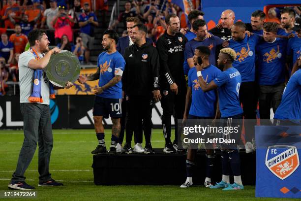 Luciano Acosta of FC Cincinnati receives the Supporter's Shield during an award presentation following an MLS soccer match against New York Red Bulls...