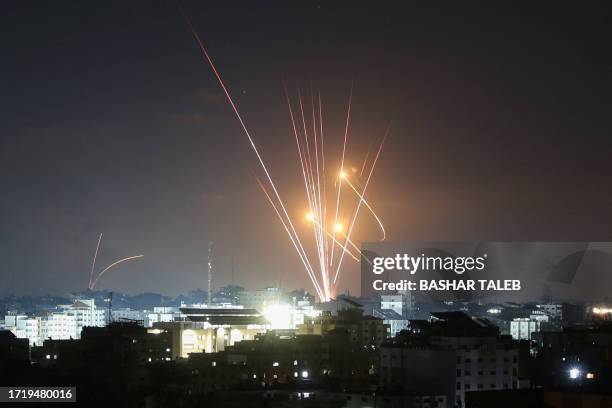 Israel's Iron Dome air defence system intercepts rockets launched from Gaza on October 11, 2023. Israel kept up its bombardment of Hamas targets in...