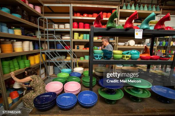 Moira Quirk of North Hollywood looks at dog bowls for sale, while shopping with her husband Michael Rayner, center, inside Bauer Pottery in Los...