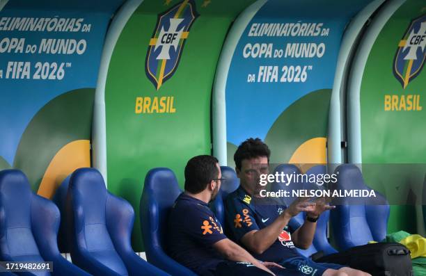 Brazil's coach Fernando Diniz talks with an assistant before a training session of the national team at the Arena Pantanal stadium in Cuiaba, Brazil,...