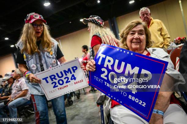 Supporters of former US President Donald Trump wait to see the president speak at a campaign rally at Club 47 USA in West Palm Beach, Florida on...