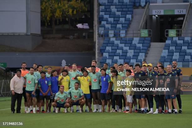 The president of the Brazilian Football Confederation , Ednaldo Rodrigues , Brazil's forward Neymar and the rest of the team pose for pictures with...
