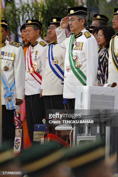 Malaysian Prime Minister Abdullah Ahmad Badawi salutes a Royal Guard of Honour during Malaysia's 50th Independence Day parade at the historic Merdeka...