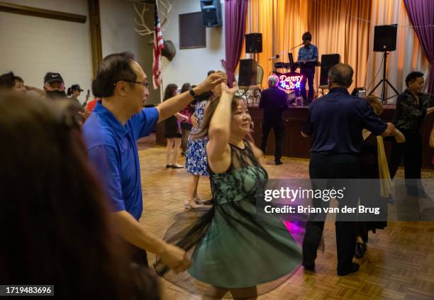 San Gabriel, CA Hattie Peng, a survivor of the Monterey Park shooting, center, twirls with a partner on the dance floor at the Elks Lodge on...