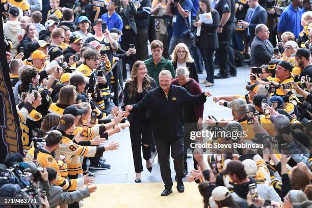 Alumni Tim Thomas of the Boston Bruins greets fans on the gold carpet during the 100th Centennial celebration before the game against the Chicago...