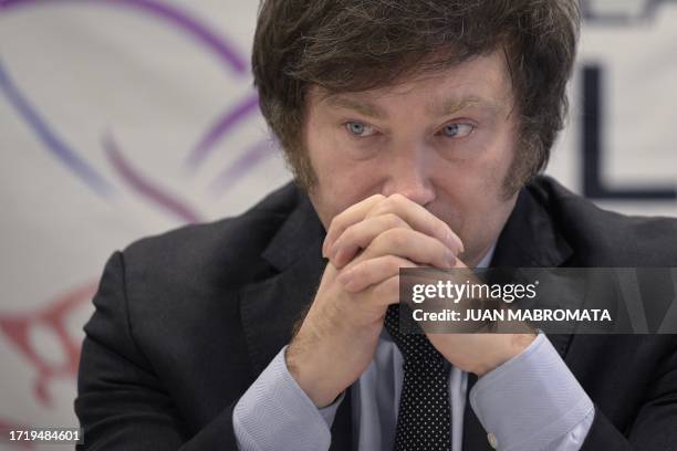 Lawmaker and presidential candidate for La Libertad Avanza party, Javier Milei, looks on during a press conference in Buenos Aires on October 11...