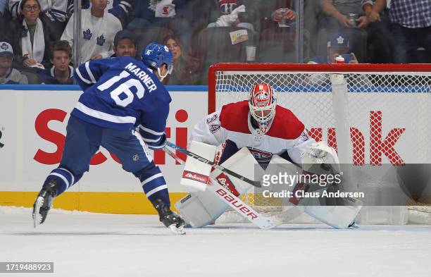 Mitchell Marner of the Toronto Maple Leafs fires the shoot-out winner past Jake Allen of the Montreal Canadiens in their season opener at Scotiabank...