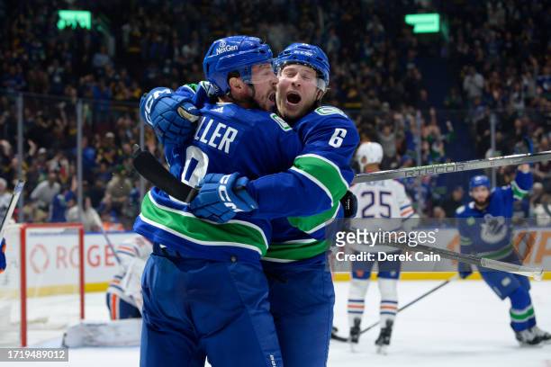 Brock Boeser is congratulated by J.T. Miller of the Vancouver Canucks after scoring a goal during the first period of their NHL game against the...