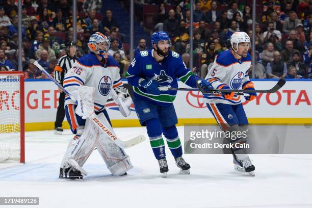 Jack Campbell and Cody Ceci of the Edmonton Oilers defend against Phillip Di Giuseppe of the Vancouver Canucks during the first period of their NHL...