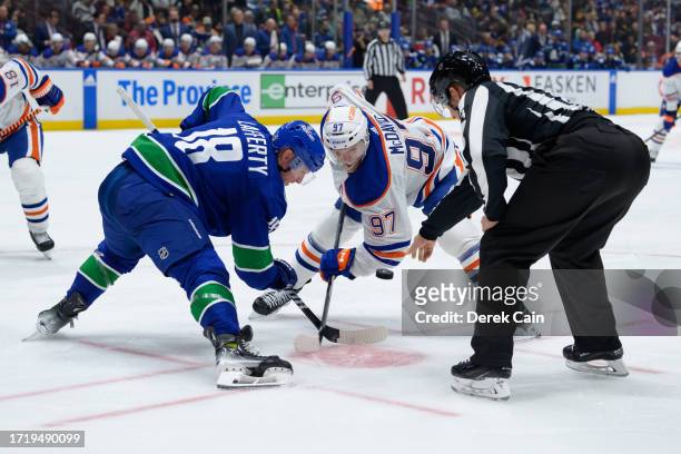 Sam Lafferty of the Vancouver Canucks faces off against Connor McDavid of the Edmonton Oilers during the second period of their NHL game at Rogers...