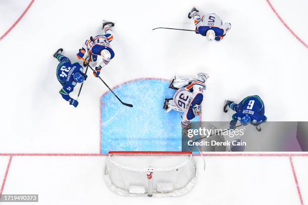 Brock Boeser of the Vancouver Canucks scores a goal on Jack Campbell of the Edmonton Oilers during the second period of their NHL game at Rogers...
