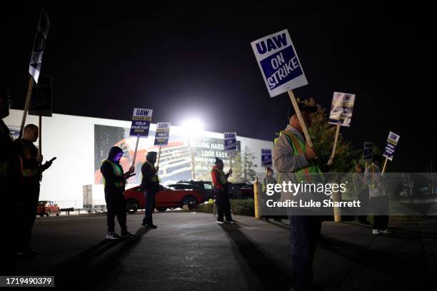 Factory workers and UAW union members form a picket line outside the Ford Motor Co. Kentucky Truck Plant in the early morning hours on October 12,...