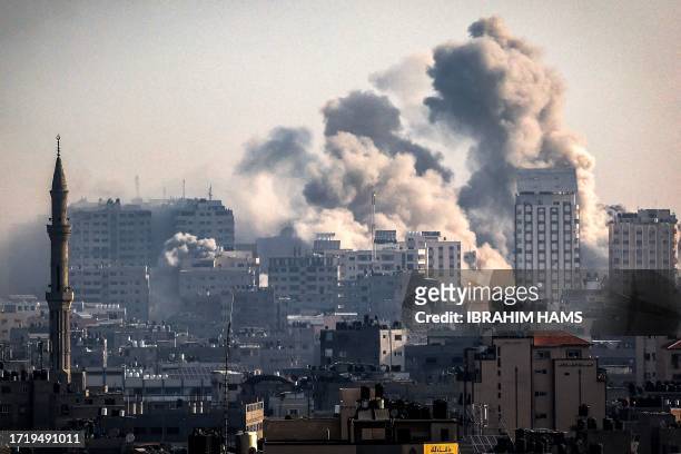 Smoke plumes billow during Israeli air strikes in Gaza City on October 12, 2023 as raging battles between Israel and the Hamas movement continue for...