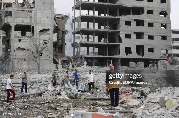 Palestinians inspect damaged buildings following the Israeli counter-strikes at Beach refugee camp in Gaza City. On Oct 7, the Palestinian militant...