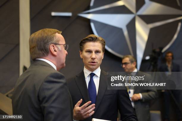 German Defence Minister Boris Pistorius speaks with Finnish Defence Minister Antti Hakkanen as they attend a NATO Council Defence Ministers Session,...