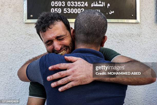 Mourners react outside the morgue of al-Shifa hospital in Gaza City on October 12, 2023 as raging battles between Israel and the Hamas movement...